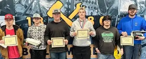 group photo of student welders holding awards